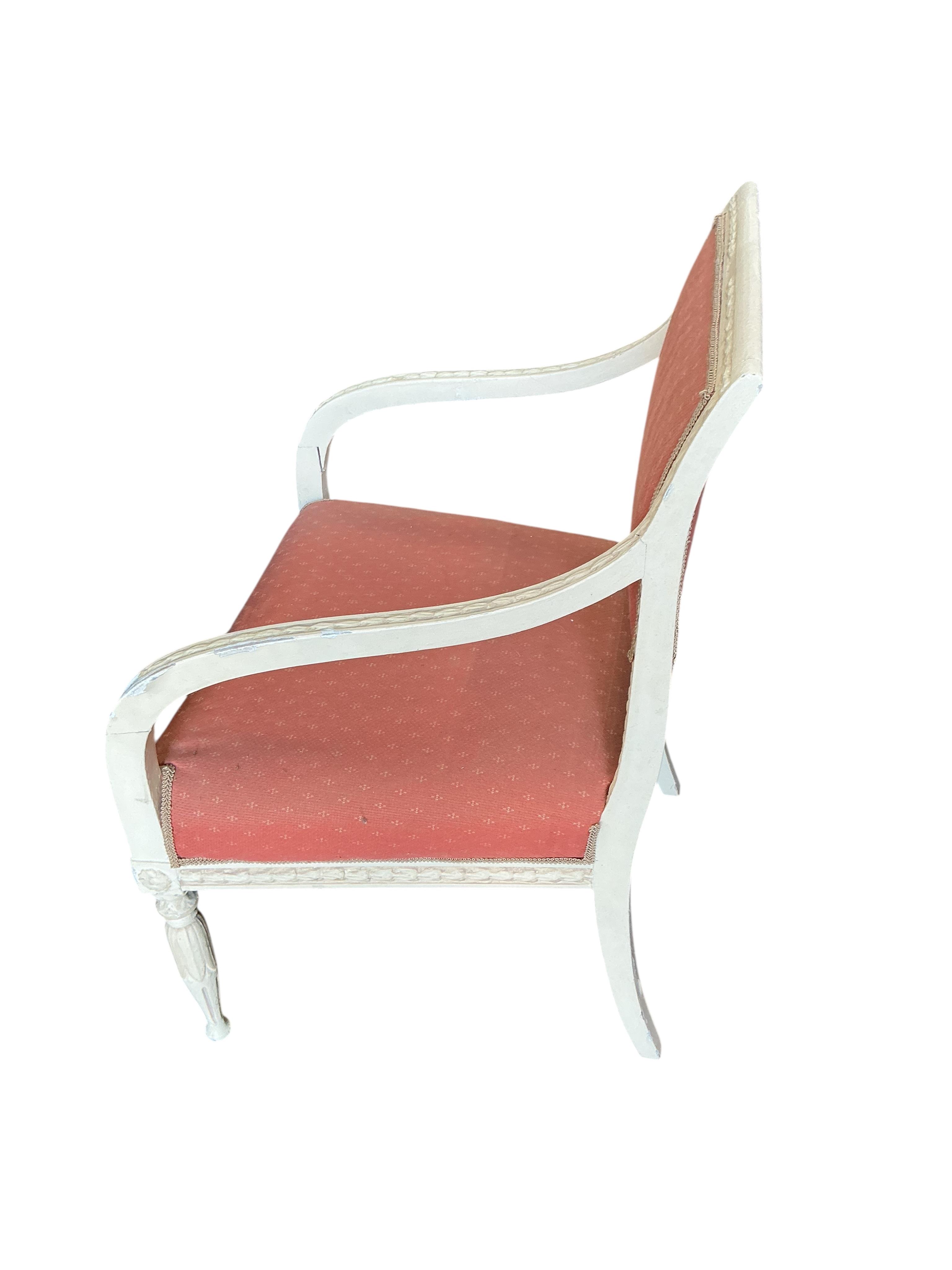 A harlequin set of six 20th century Louis XVI style white painted chairs with red upholstery